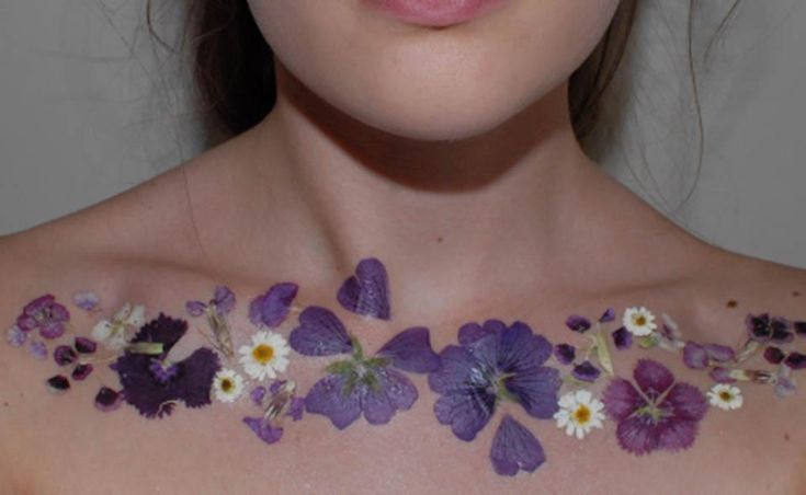 a woman with flowers painted on her chest