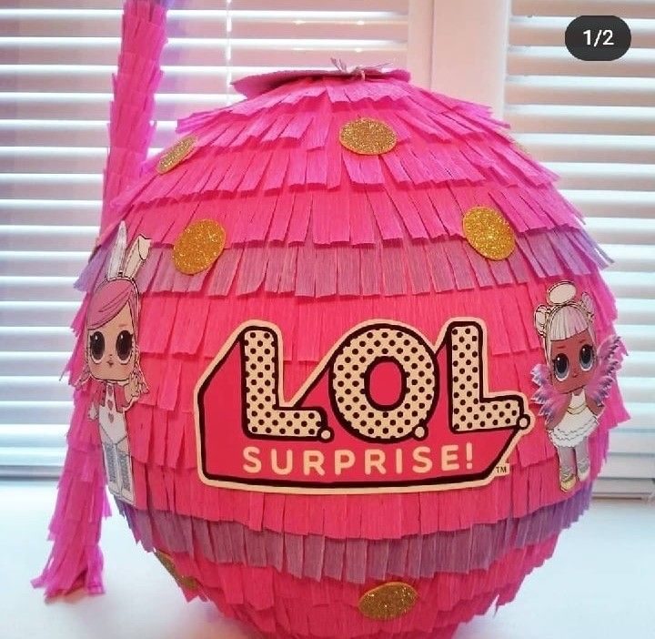 a pink lol surprise pinata sitting on top of a table