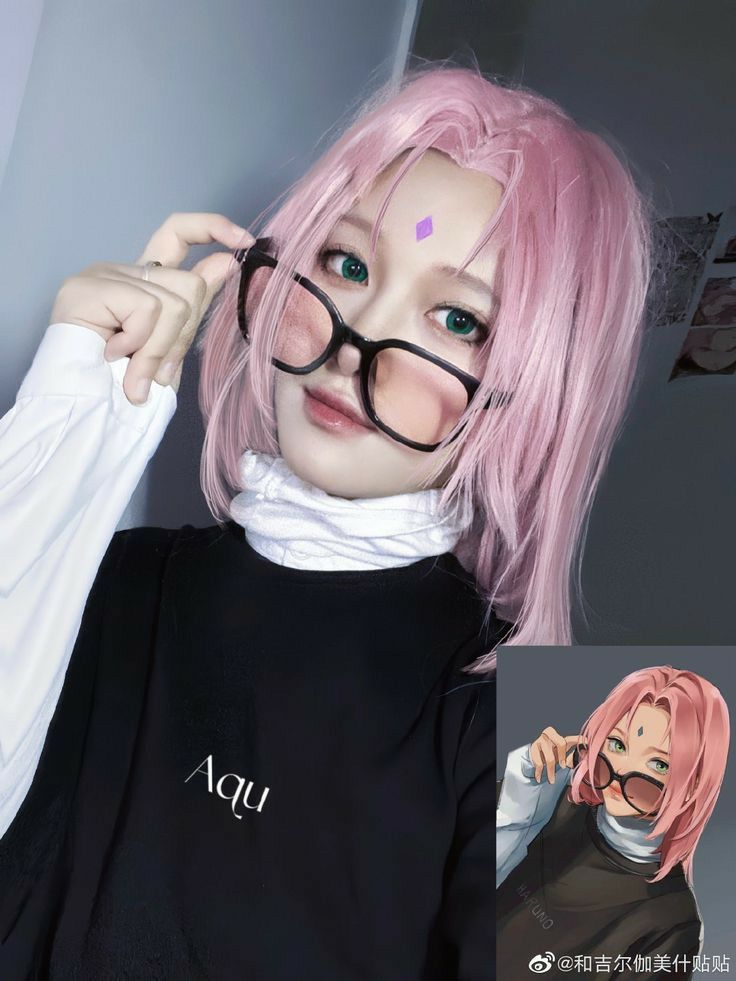 a woman with pink hair and glasses is posing for the camera while wearing a black shirt