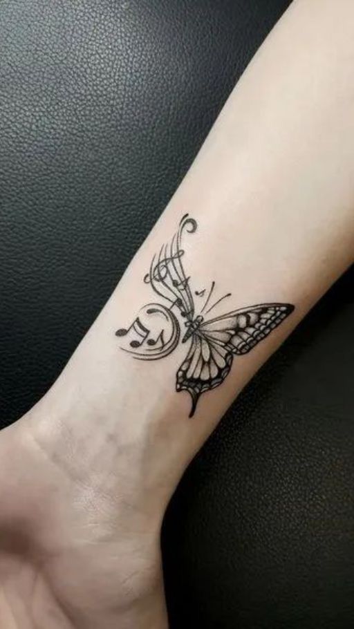 a small butterfly tattoo on the wrist