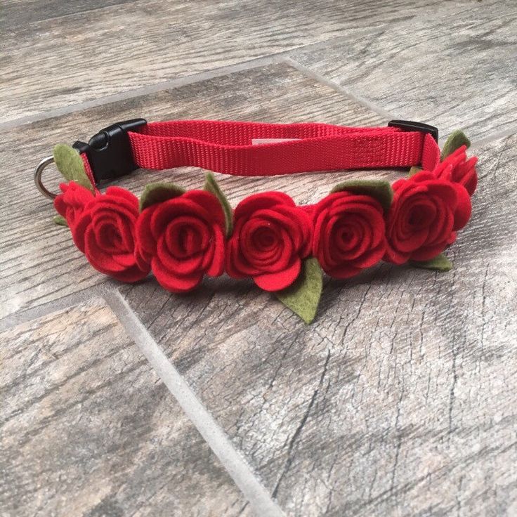 a red flowered headband with green leaves