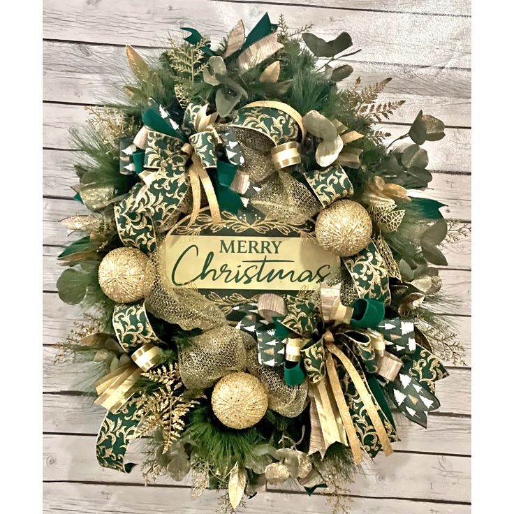 a christmas wreath with green and gold decorations