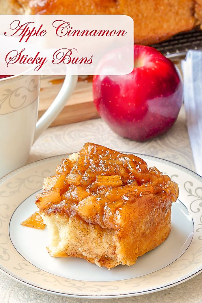 a piece of apple cinnamon sticky buns on a plate with an apple in the background