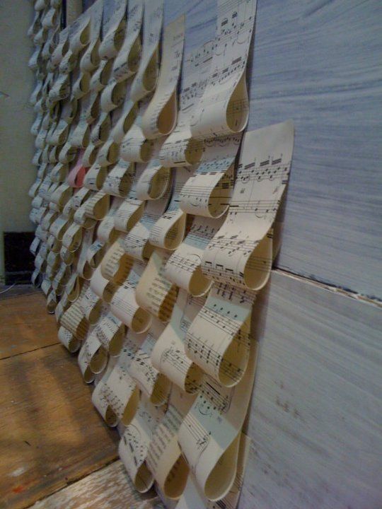 several pieces of music paper are arranged on a wall