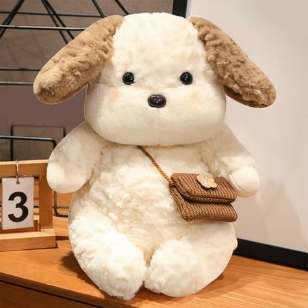 a white stuffed animal sitting on top of a wooden table next to a small clock