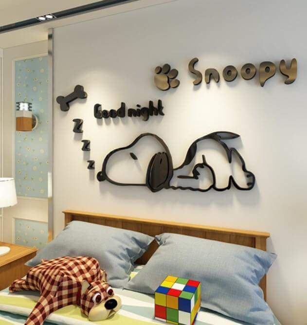 there is a bed with a teddy bear on the headboard and some letters above it