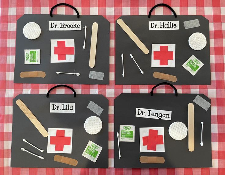 four pieces of paper cut out to look like medical equipment on a table with red and white checkered cloth