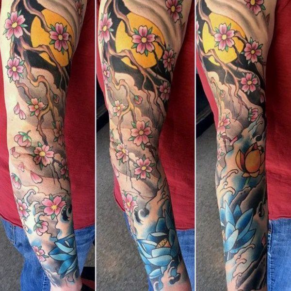 the arm is decorated with flowers and birds on it's sides, along with other tattoos