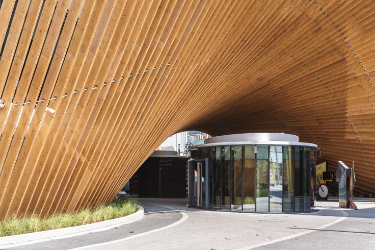 a curved building with wooden slats covering it