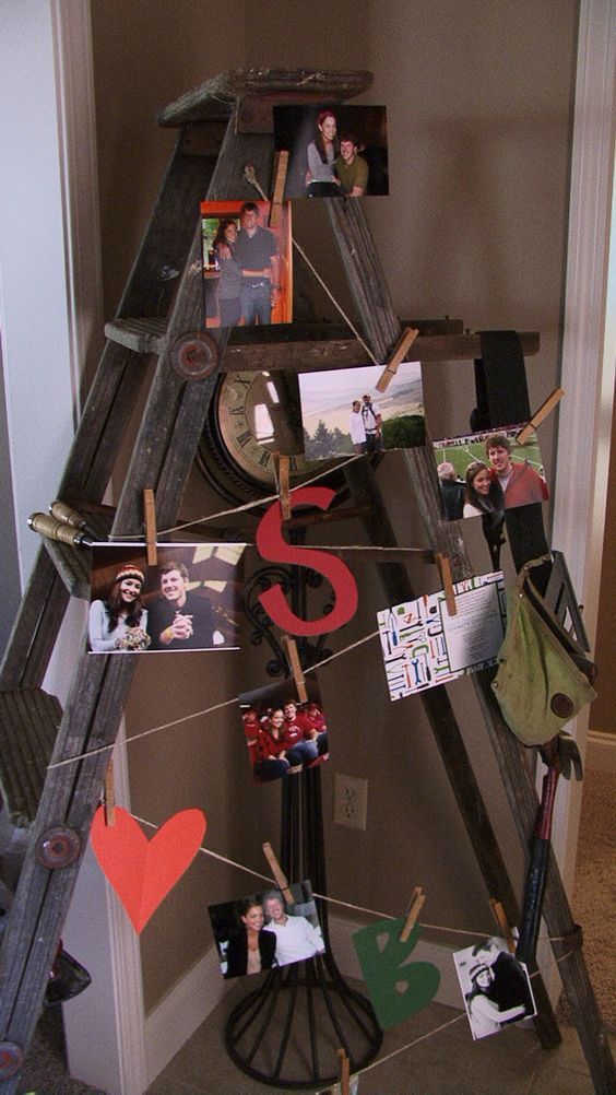 there is a ladder with pictures on it and clothes pins attached to the top one