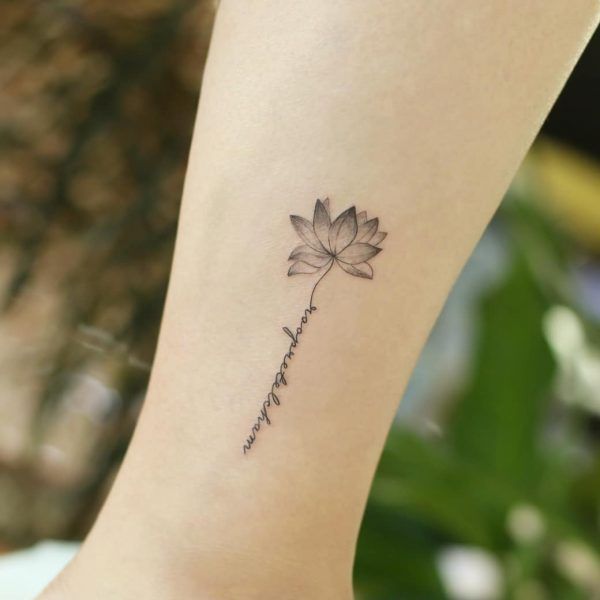 a lotus flower tattoo on the ankle