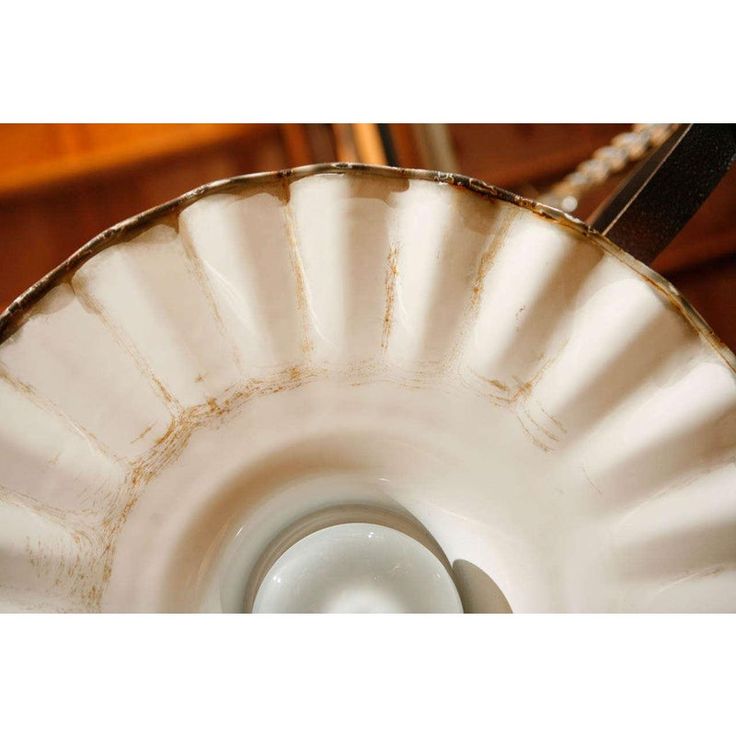 a close up of a white bowl on a table