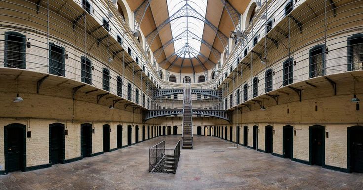 the inside of a jail cell with stairs and railings