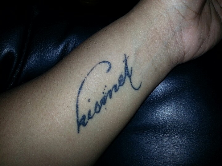 a person with a tattoo on their arm that reads,'forever'in cursive writing