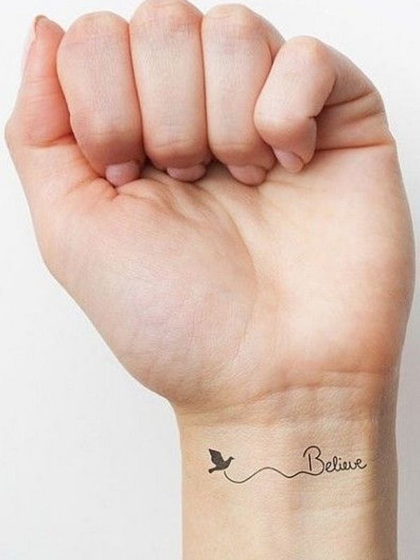 a woman's arm with a small tattoo on it that says believe and a bird