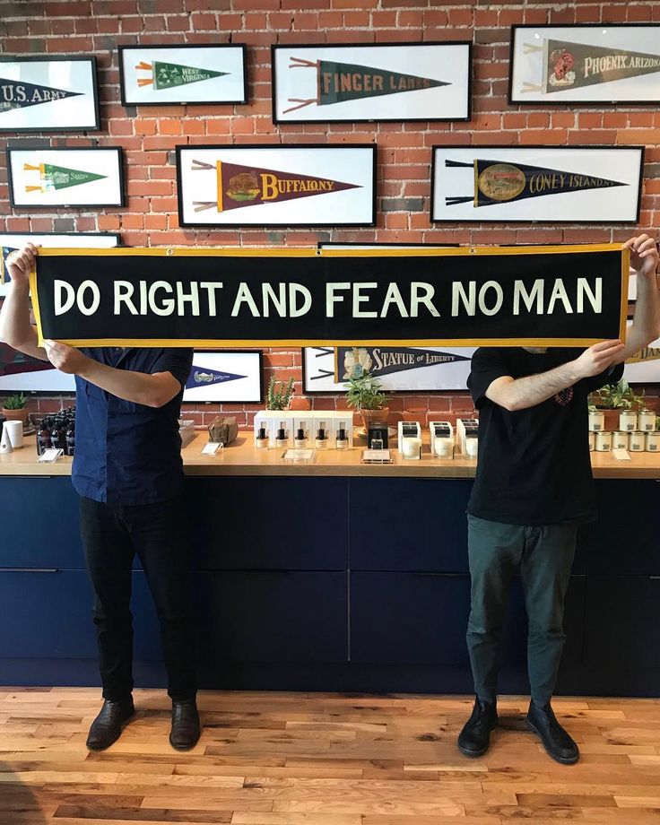 two men holding up a sign that says do right and fear no man