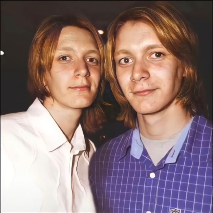 two young men standing next to each other