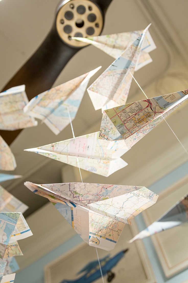 a wind chime with paper airplanes hanging from it