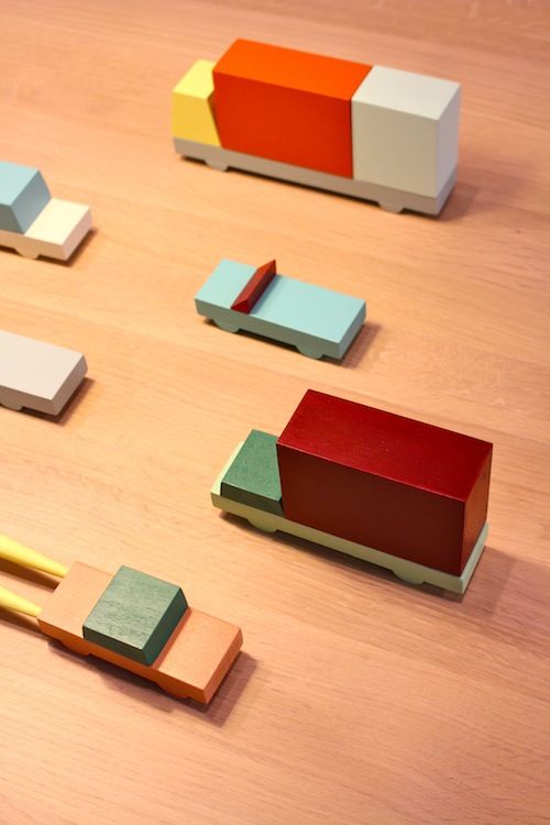 several different colored pieces of wood sitting on top of a wooden table