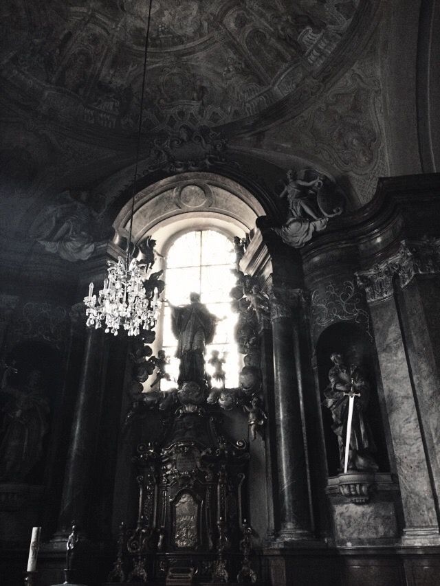 the interior of a church with chandelier and statues on it's walls