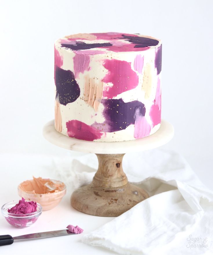 a cake with pink and purple paint on it