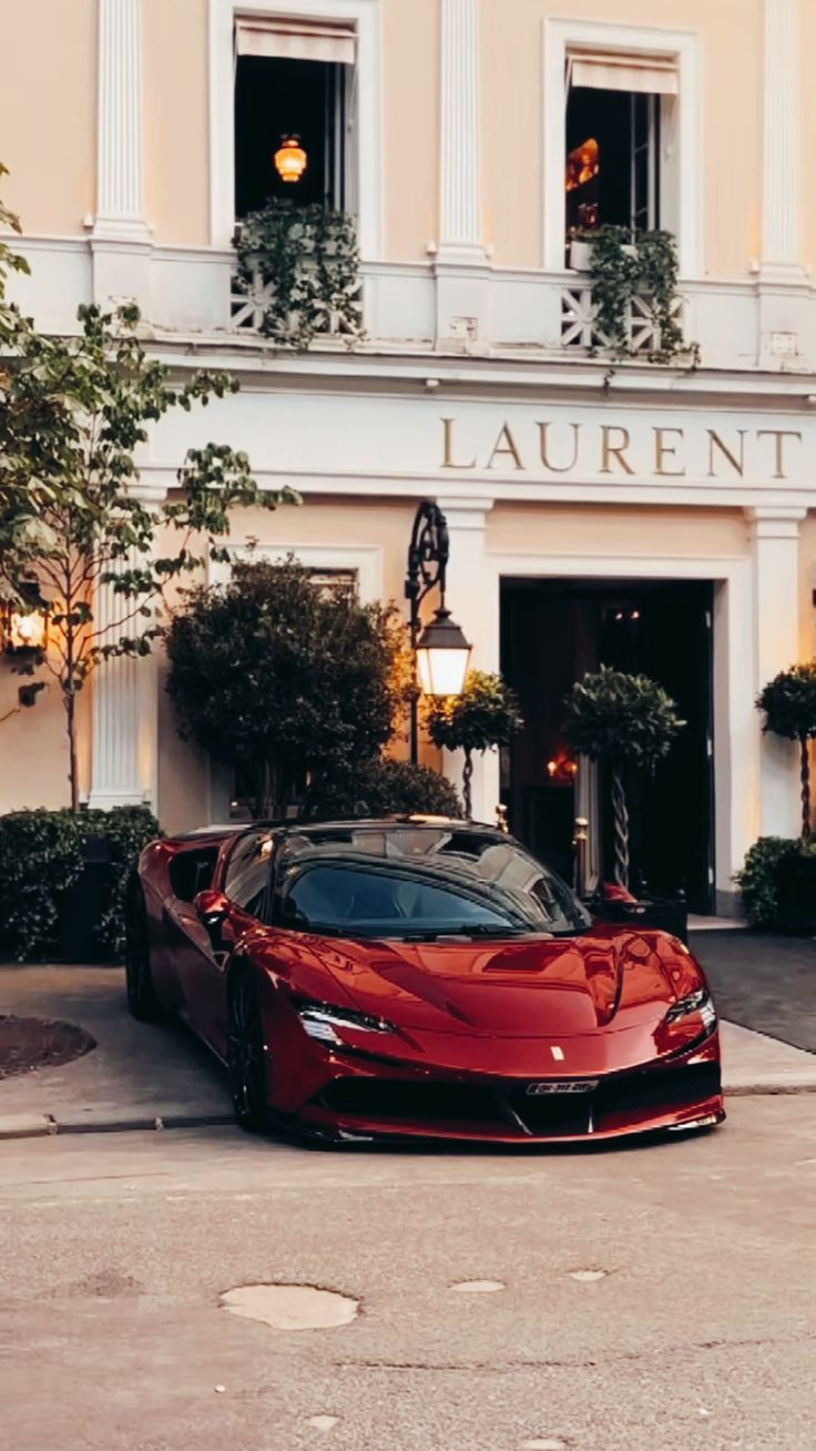 a red sports car parked in front of a building