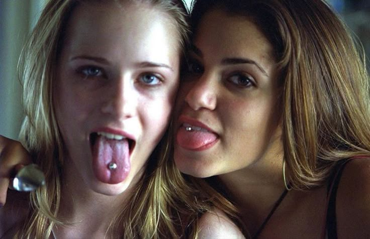 two young women making funny faces with their mouths open and tongue hanging out to the side