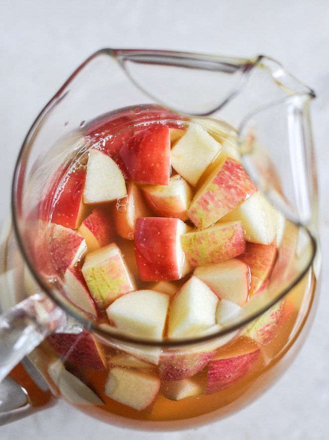 a pitcher filled with watermelon and apple slices