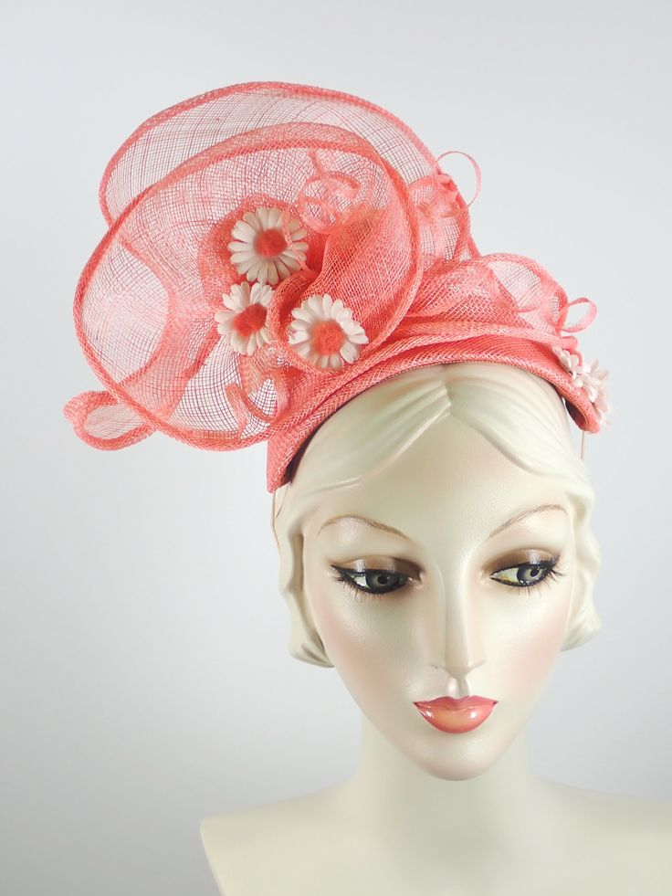 This women's peach/coral fascinator hat is a sure bet for Kentucky Derby or Kentucky Oaks. Or any summer event really, like church, ladies tea, or just for fun. It is made with sinamay straw and is very light and airy. The hand sculpted sinamay sits atop a handmade bandeau base and is secured with an elastic band that goes behind the ears and head to keep the hat in place. It is topped with vintage daisies and hand rolled sinamay leaves as well as sinamay swirls for added texture. An inner grosg Kentucky Oaks, Mother Of The Bride Hats, Ladies Tea, Custom Made Hats, Large Brim Hat, Sinamay Fascinator, Handmade Hats, Types Of Hats, Bridal Hat