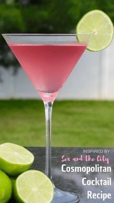 the pink cocktail is garnished with limes