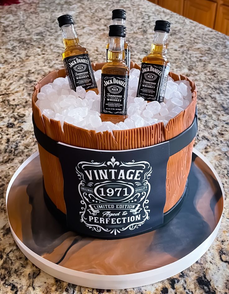 an ice bucket filled with bottles of whiskey on top of a counter