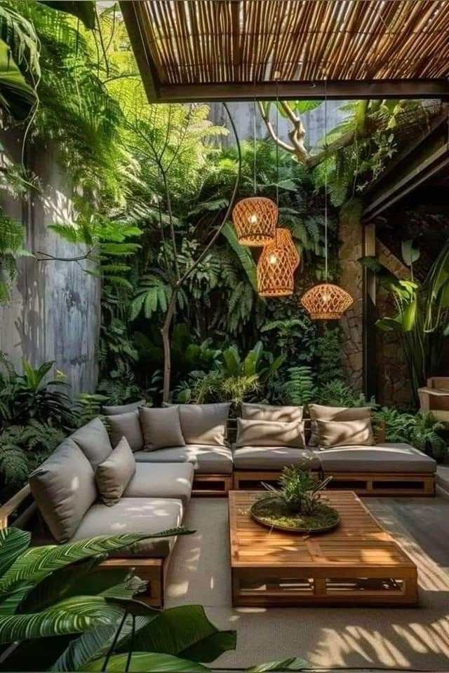 an outdoor living room with lots of plants