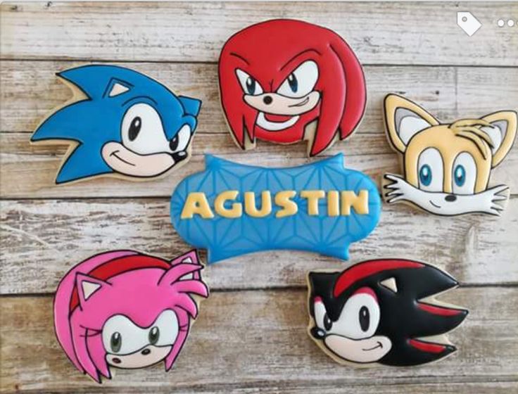 four sonic the hedgehog cookies are sitting on a wooden table with words that say,'augustin '