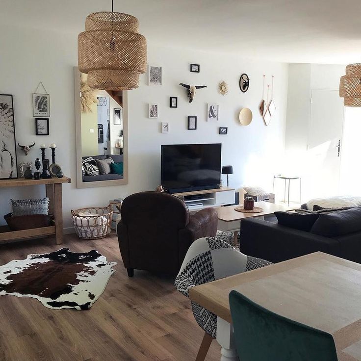 a living room filled with furniture and a flat screen tv sitting on top of a hard wood floor