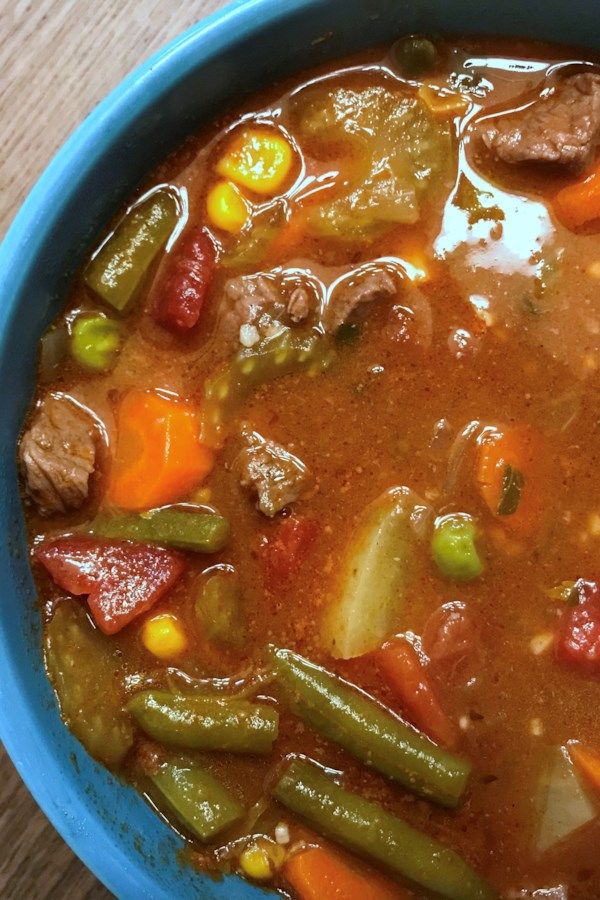 a blue bowl filled with meat and vegetables