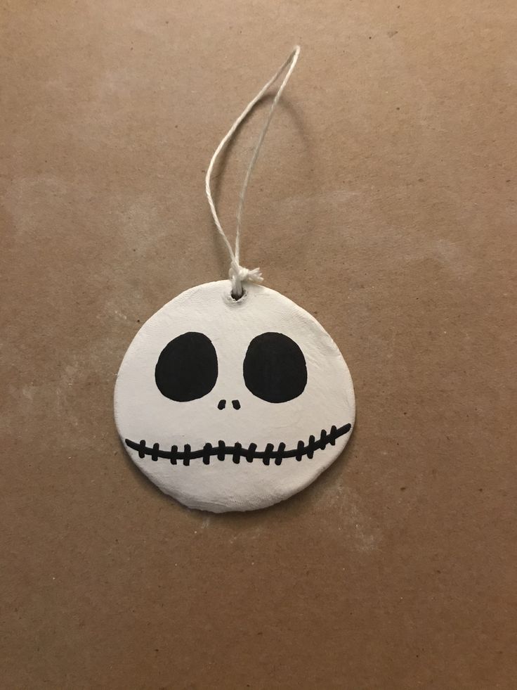 a white ornament with black eyes and a skeleton face on it's side