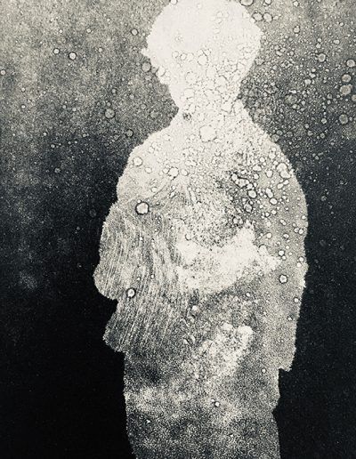 a black and white photo of a person standing in front of water drops on the ground