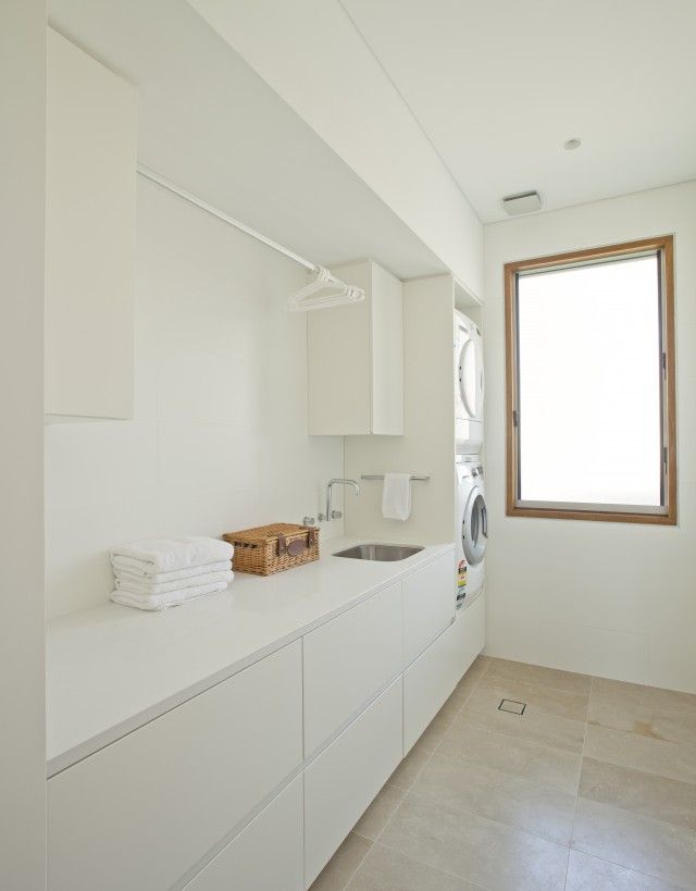 a washer and dryer in a white laundry room