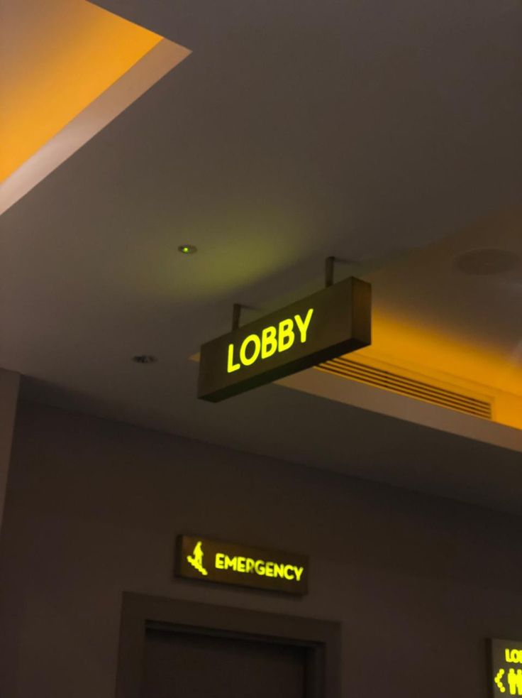 there is a lobby sign above the door and below it are emergency lights on the ceiling