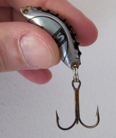 a person holding a fishing hook in their hand