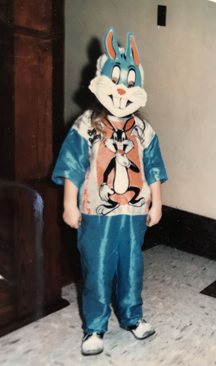 a young child wearing a blue and orange bunny costume