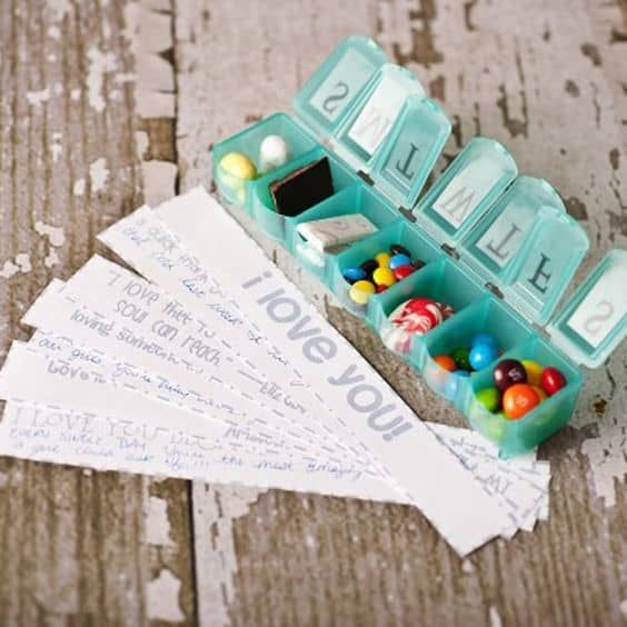 some type of pill box sitting on top of a wooden table with candy in it