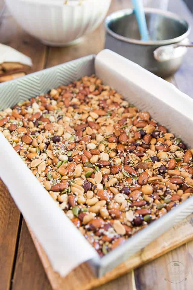 a pan filled with nuts sitting on top of a wooden table