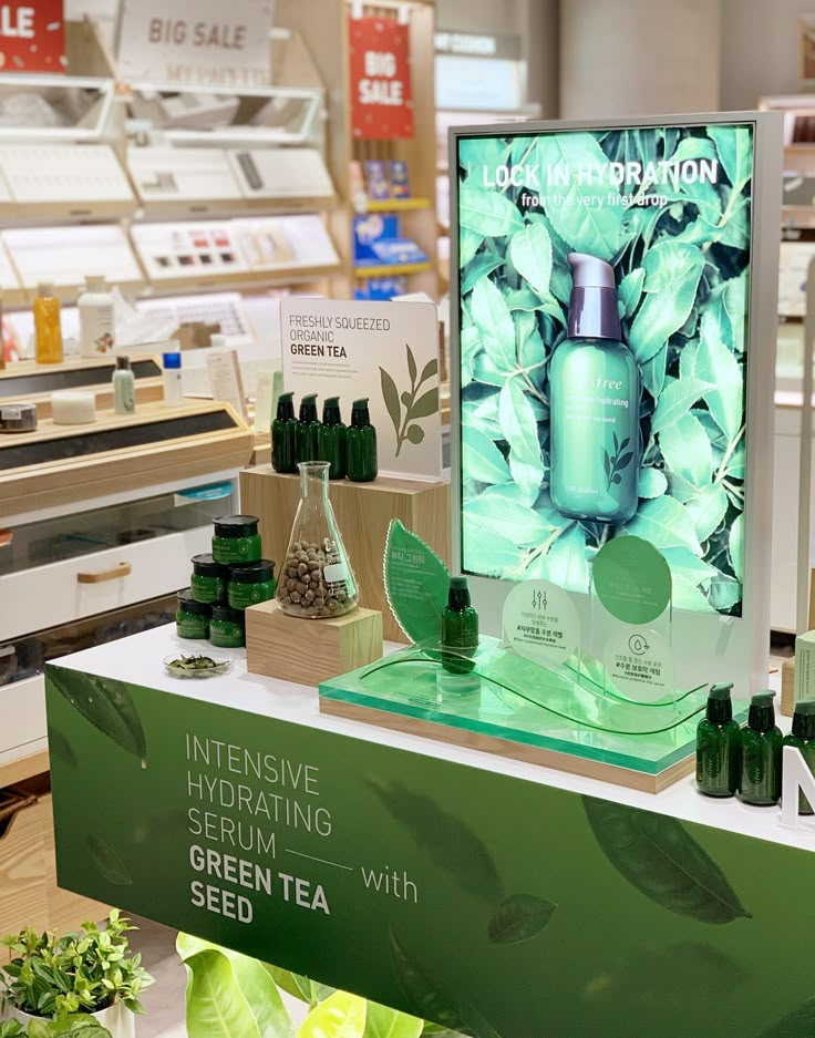 a display in a store filled with lots of bottles and containers full of green tea