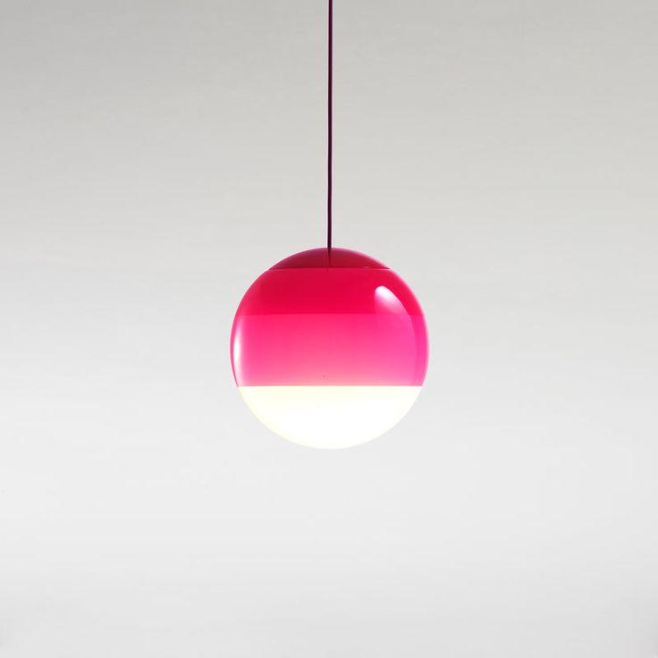 a pink and white light hanging from a ceiling