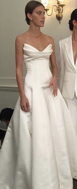 two women in white dresses standing next to each other