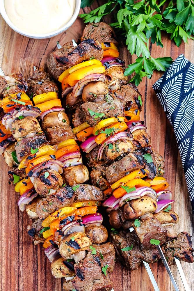 the skewers are covered with meat and vegetables