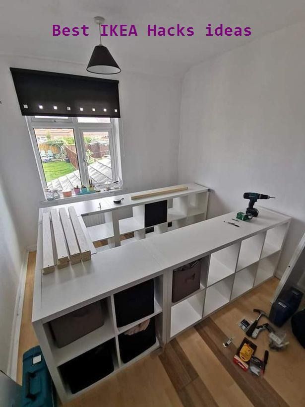 an empty room with white shelves and windows