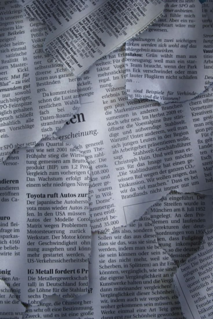 torn newspaper paper with the word news written on it and ripped up into smaller pieces