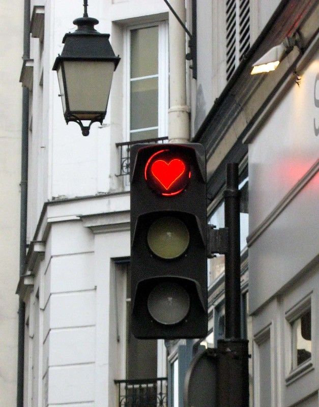 a traffic light with a heart painted on it